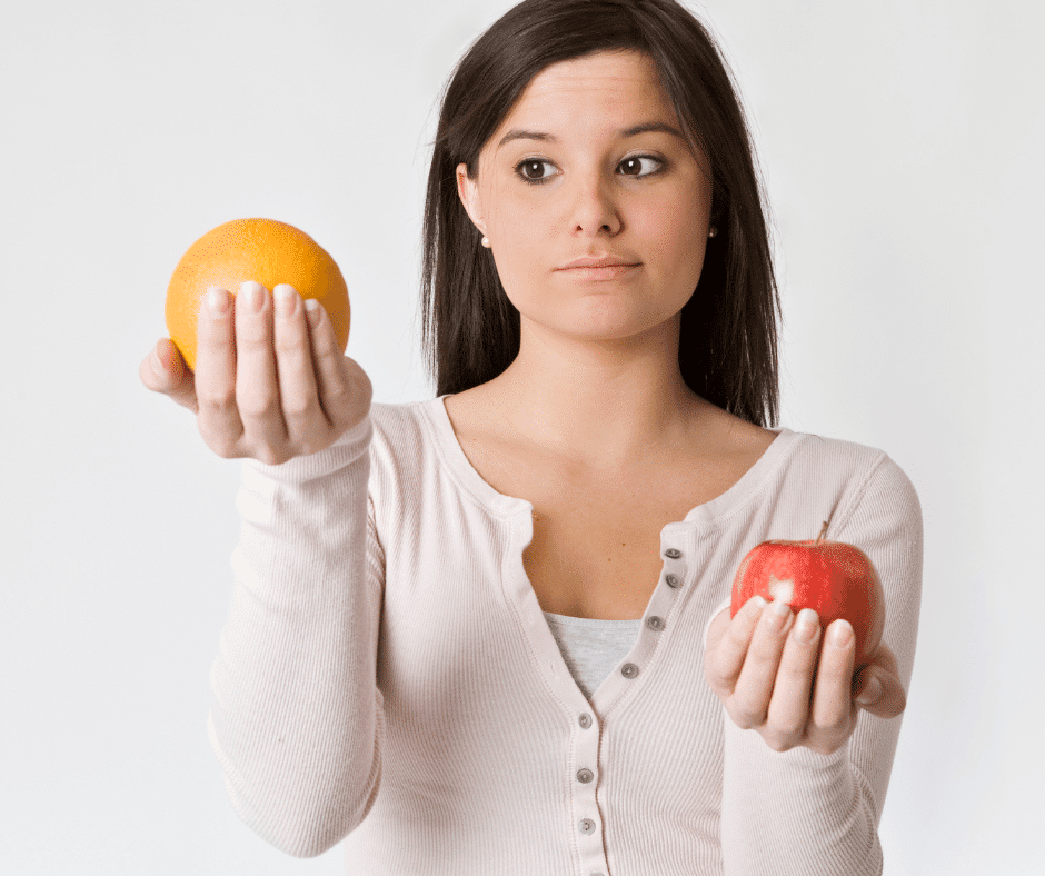 woman hold apple and orange